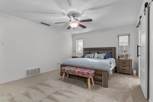 bedroom with crown molding, light colored carpet, a barn door, and ceiling fan