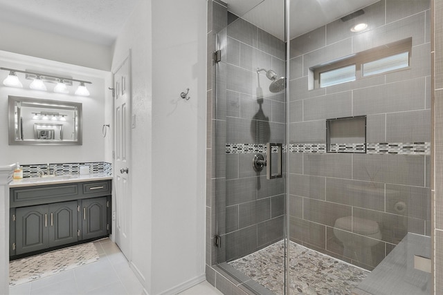 bathroom featuring an enclosed shower, vanity, and tile patterned floors