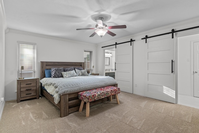 carpeted bedroom with crown molding, ensuite bath, a barn door, and ceiling fan