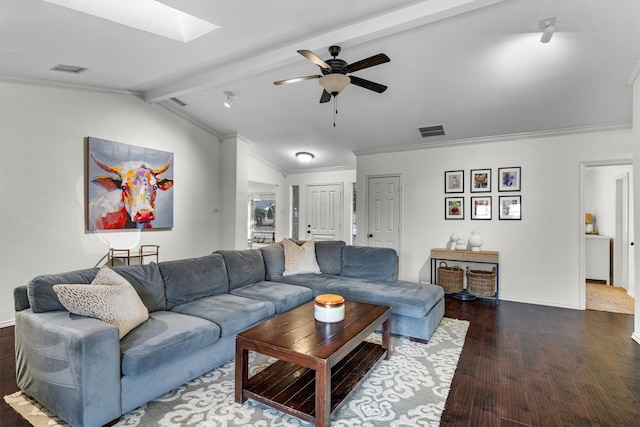 living room featuring lofted ceiling with skylight, dark wood-type flooring, ceiling fan, and ornamental molding