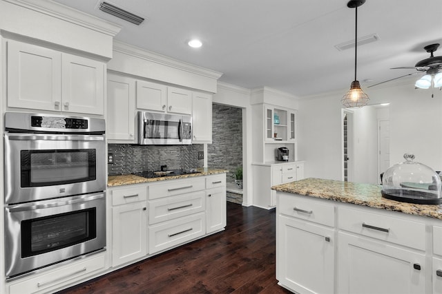 kitchen with white cabinets, decorative backsplash, ornamental molding, light stone counters, and stainless steel appliances