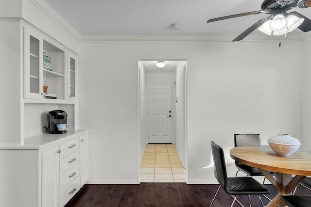 dining space with ornamental molding, hardwood / wood-style floors, and ceiling fan