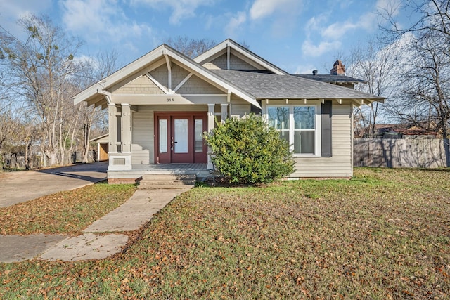 view of front facade featuring a front lawn and french doors