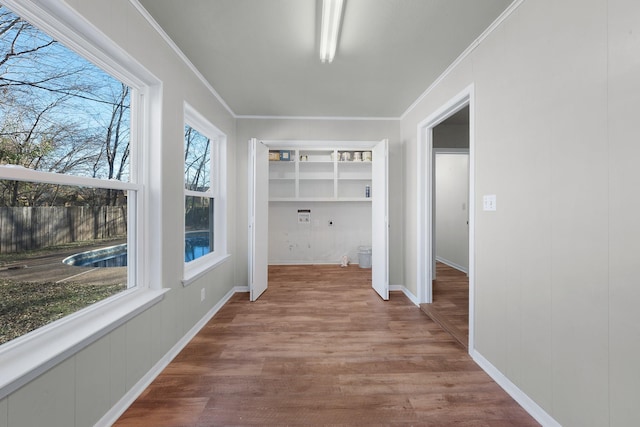 hall featuring crown molding and hardwood / wood-style floors