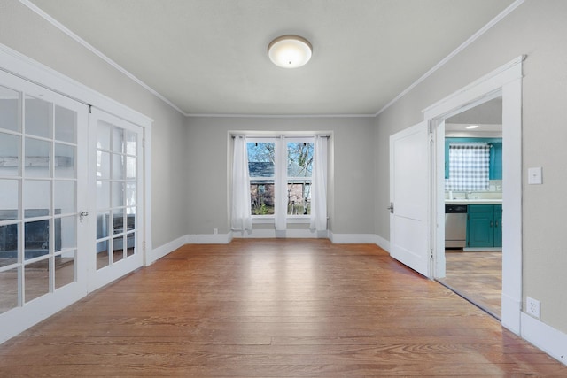 unfurnished room with light hardwood / wood-style floors, ornamental molding, and french doors