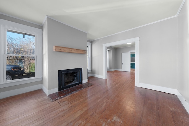 unfurnished living room featuring a fireplace, dark wood-type flooring, plenty of natural light, and ornamental molding