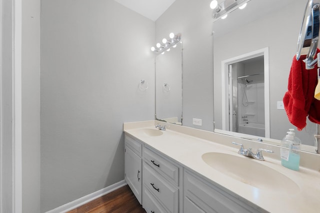 bathroom with vanity, hardwood / wood-style flooring, and bathing tub / shower combination