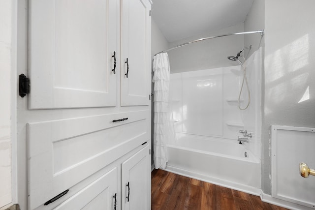 bathroom with wood-type flooring and shower / bathtub combination with curtain