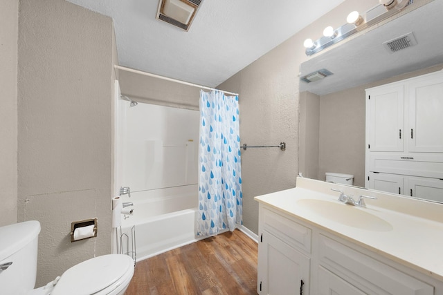 full bathroom featuring hardwood / wood-style floors, vanity, toilet, and shower / bath combo