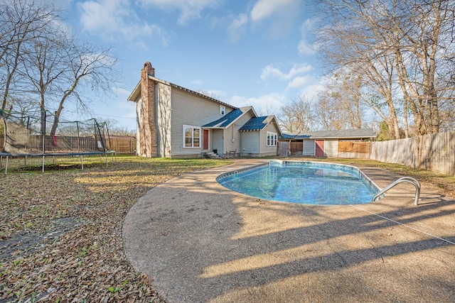 view of swimming pool featuring a patio and a trampoline