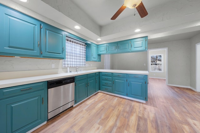 kitchen with blue cabinets, light hardwood / wood-style flooring, stainless steel dishwasher, ceiling fan, and tasteful backsplash