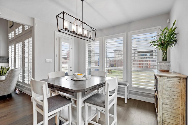 dining room featuring dark hardwood / wood-style floors and a chandelier