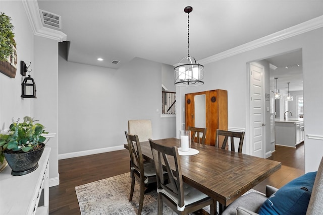 dining space with an inviting chandelier, ornamental molding, dark hardwood / wood-style flooring, and sink