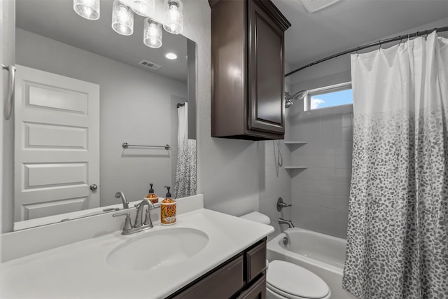 full bathroom featuring vanity, shower / tub combo with curtain, and toilet