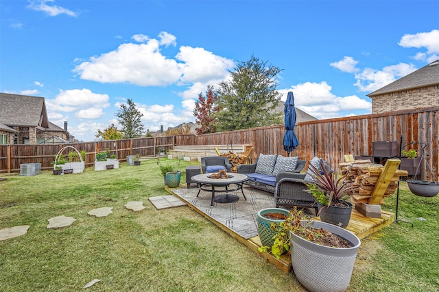 view of yard featuring a patio and an outdoor living space with a fire pit