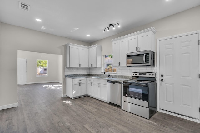 kitchen featuring white cabinets, sink, stainless steel appliances, and light hardwood / wood-style flooring