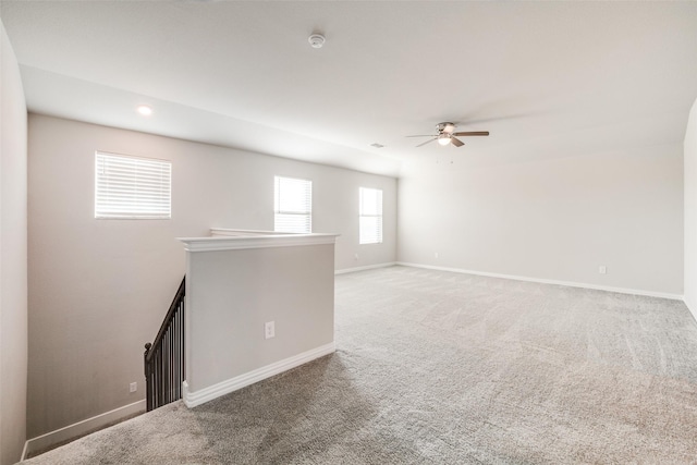 empty room featuring carpet floors and ceiling fan