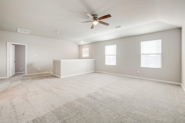 carpeted empty room with ceiling fan and vaulted ceiling