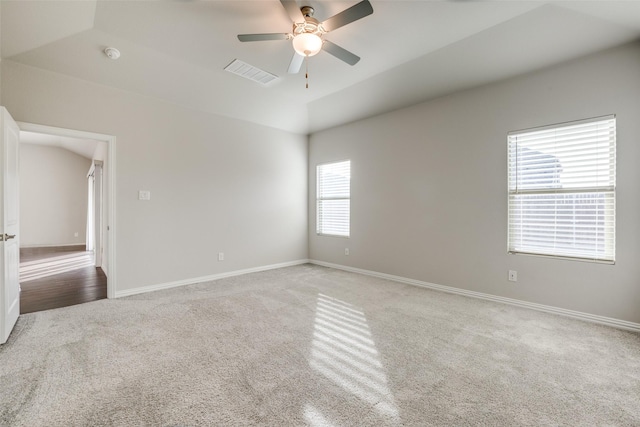 empty room with ceiling fan and carpet