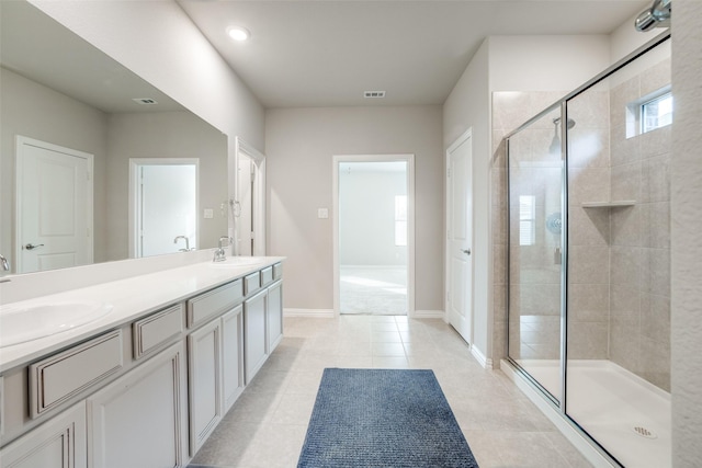 bathroom with tile patterned flooring, vanity, and a shower with shower door