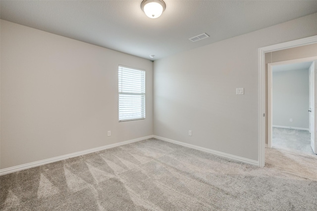 unfurnished room featuring light colored carpet