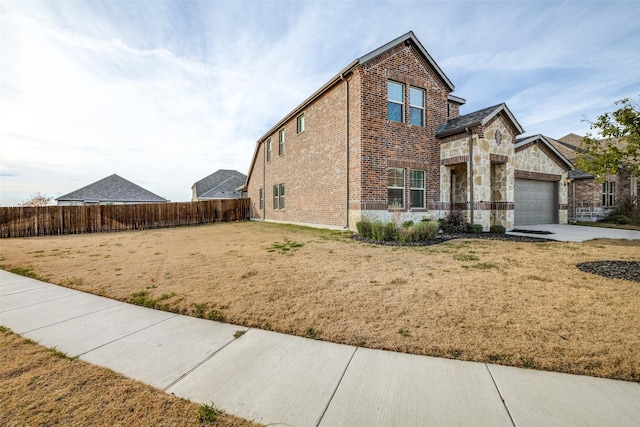 view of front of property with a garage and a front yard