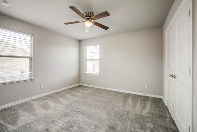 unfurnished bedroom with ceiling fan and carpet floors