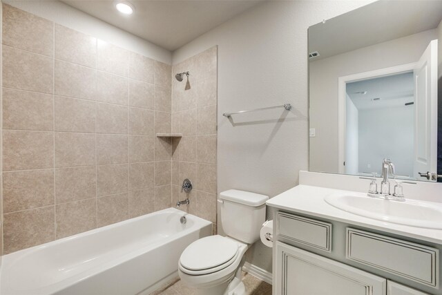 full bathroom with vanity, toilet, and tiled shower / bath