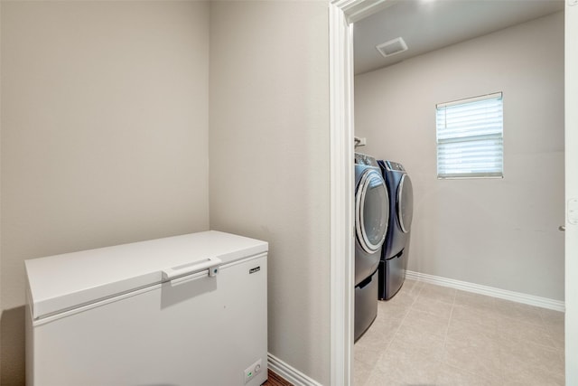 clothes washing area featuring washer and dryer