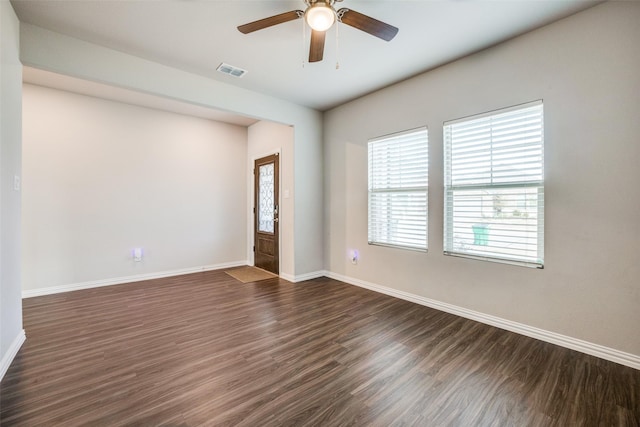 empty room with dark hardwood / wood-style floors and ceiling fan