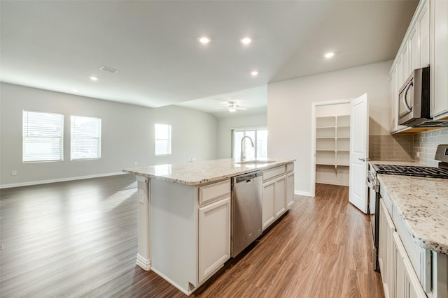 kitchen with sink, white cabinetry, an island with sink, and appliances with stainless steel finishes