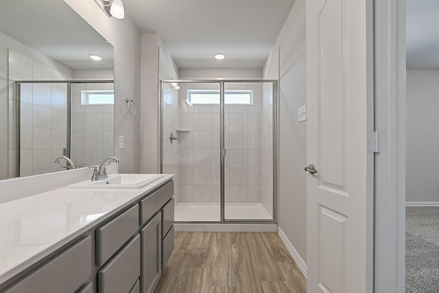 bathroom with vanity, wood-type flooring, and walk in shower