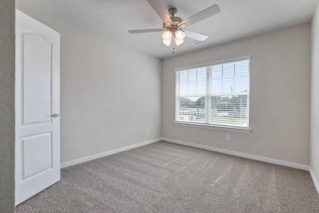 empty room featuring carpet and ceiling fan