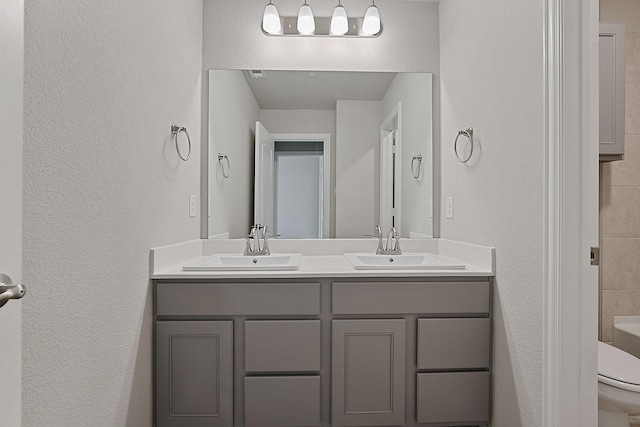 bathroom featuring vanity and toilet