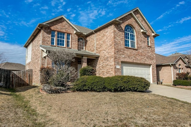 view of property featuring a garage and a front lawn