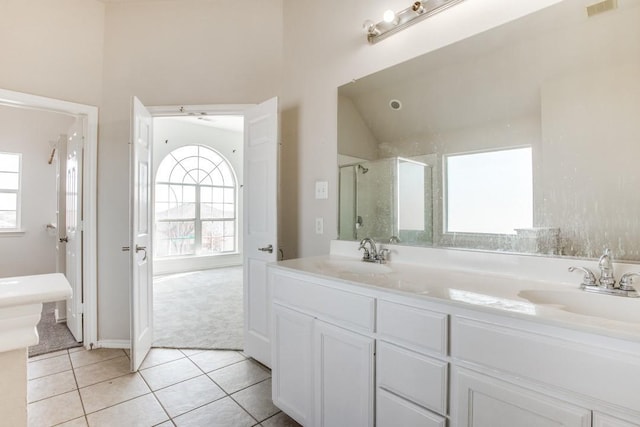 bathroom featuring tile patterned flooring, vanity, walk in shower, and ceiling fan