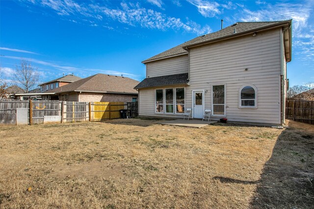 back of house featuring a yard and a patio area