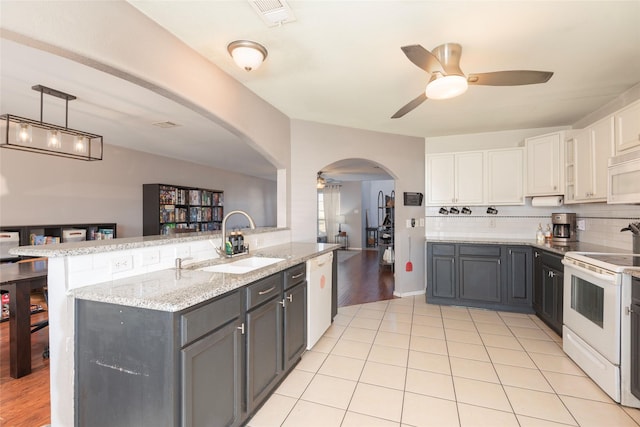 kitchen featuring gray cabinets, decorative light fixtures, white cabinetry, sink, and white appliances