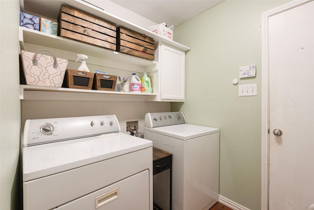 laundry area with cabinets and independent washer and dryer