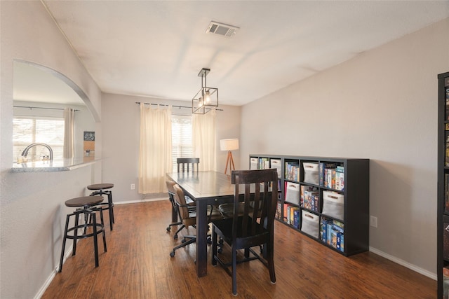 dining room featuring dark hardwood / wood-style flooring, sink, and a wealth of natural light