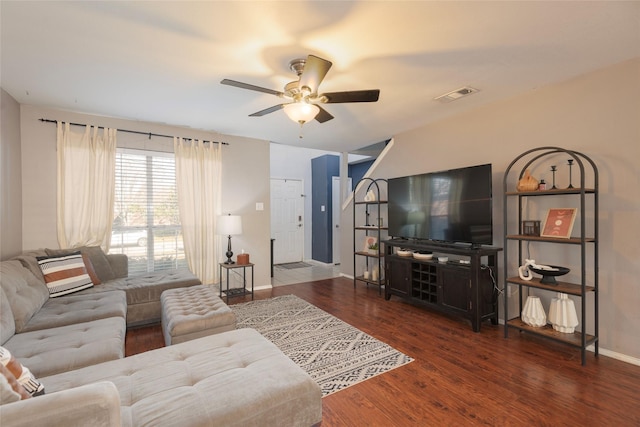 living room with dark hardwood / wood-style flooring and ceiling fan