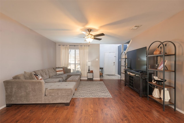 living room with dark wood-type flooring and ceiling fan