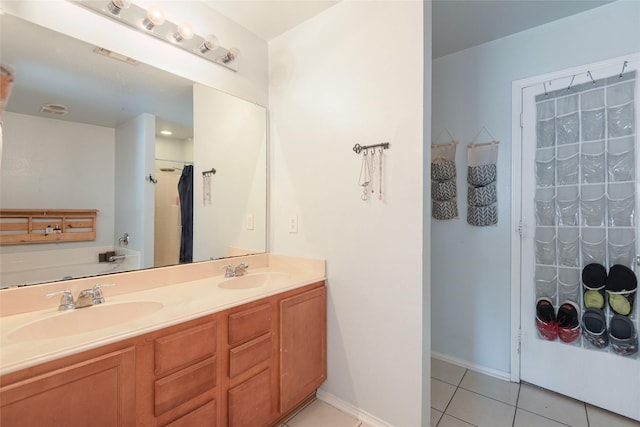 bathroom featuring tile patterned flooring, vanity, and a bathtub