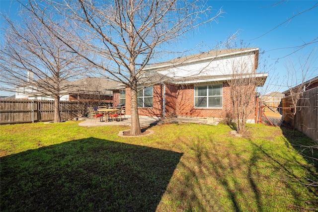 rear view of property featuring a patio area and a lawn