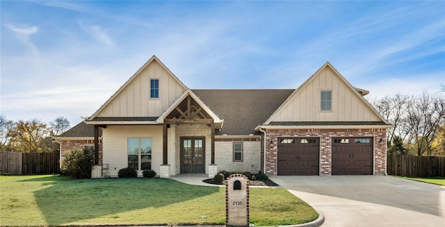 view of front of property featuring french doors, a front yard, and a garage