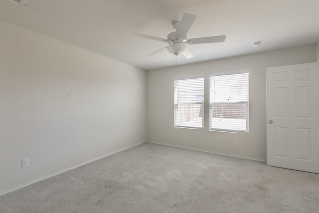 empty room featuring ceiling fan and light colored carpet