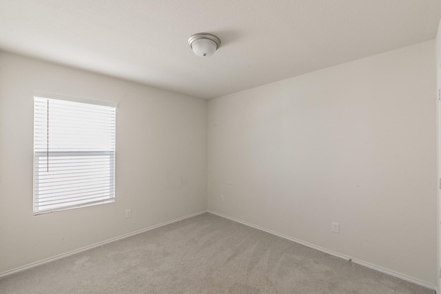 unfurnished room with light carpet