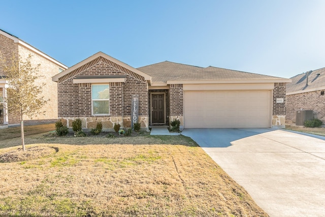 single story home featuring a garage, a front yard, and central air condition unit