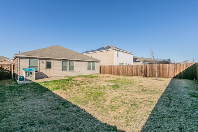 rear view of house featuring a yard and a patio area