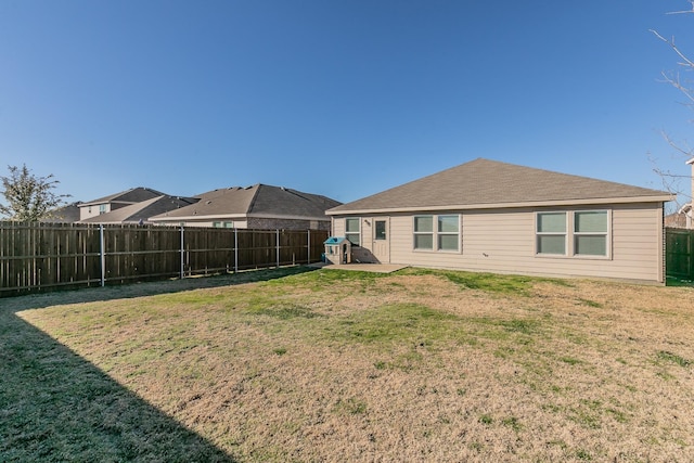 back of property featuring a lawn